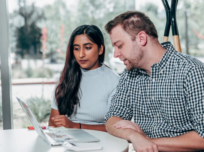 Business consultant collaborating with a client on a digital whiteboard.